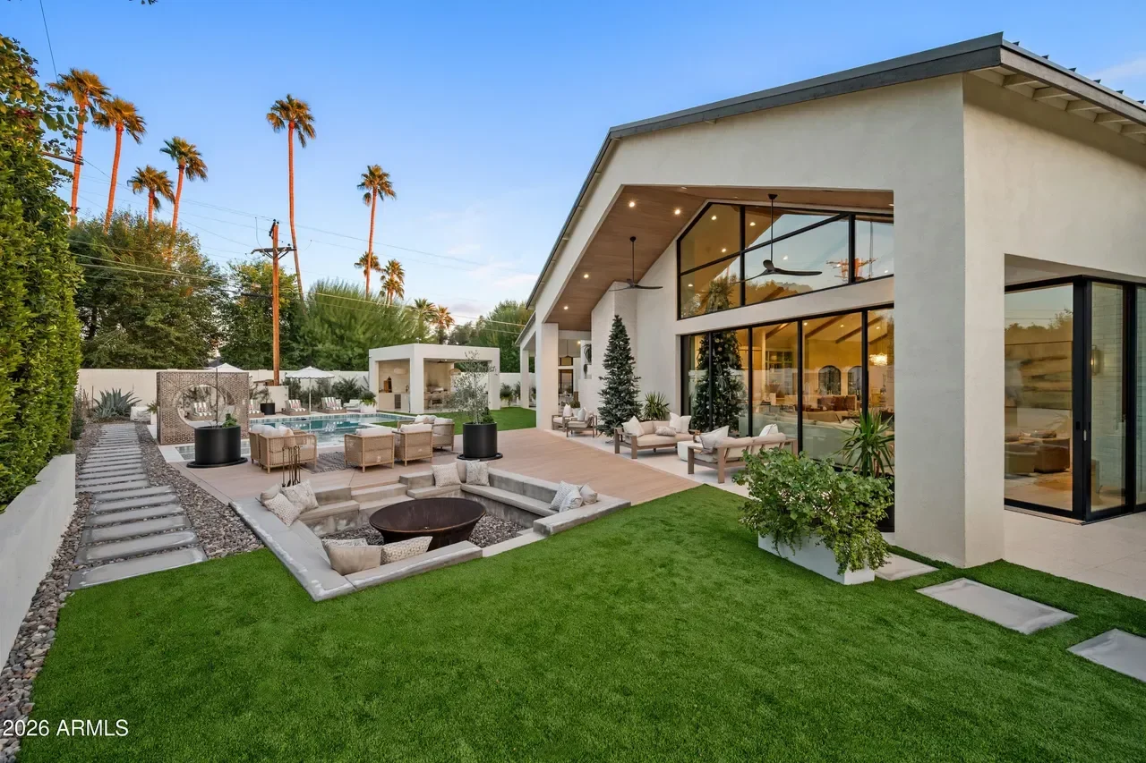 Modern backyard with fire pit, pool, patio decking, synthetic turf, and contemporary home exterior